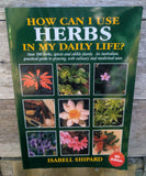 Book titled 'How Can I Use Herbs in My Daily Life?' by Isabell Shipard on a wooden surface