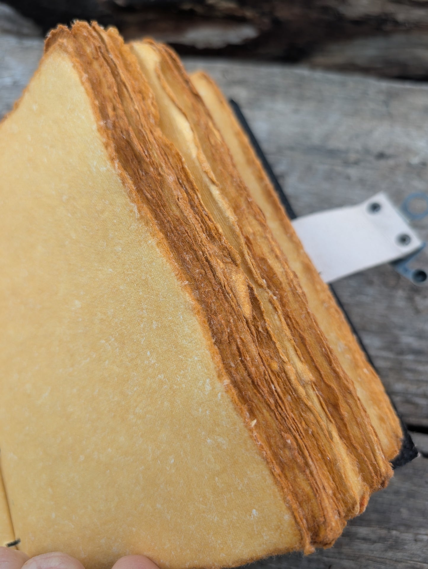 Open Sun & Moon leather journal showing handmade deckle edge paper and sturdy binding