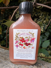 Bottle of 'Summer Fruits' vinegar on a wooden surface with a natural background
