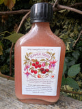 Bottle of 'Summer Fruits' vinegar on a wooden surface with a natural background