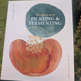 Book titled 'The Japanese Art of Pickling & Fermenting' held in front of a natural background
