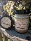 Jar of 'Healthy Gut Prebiotic Honey' on a wooden surface with a natural background