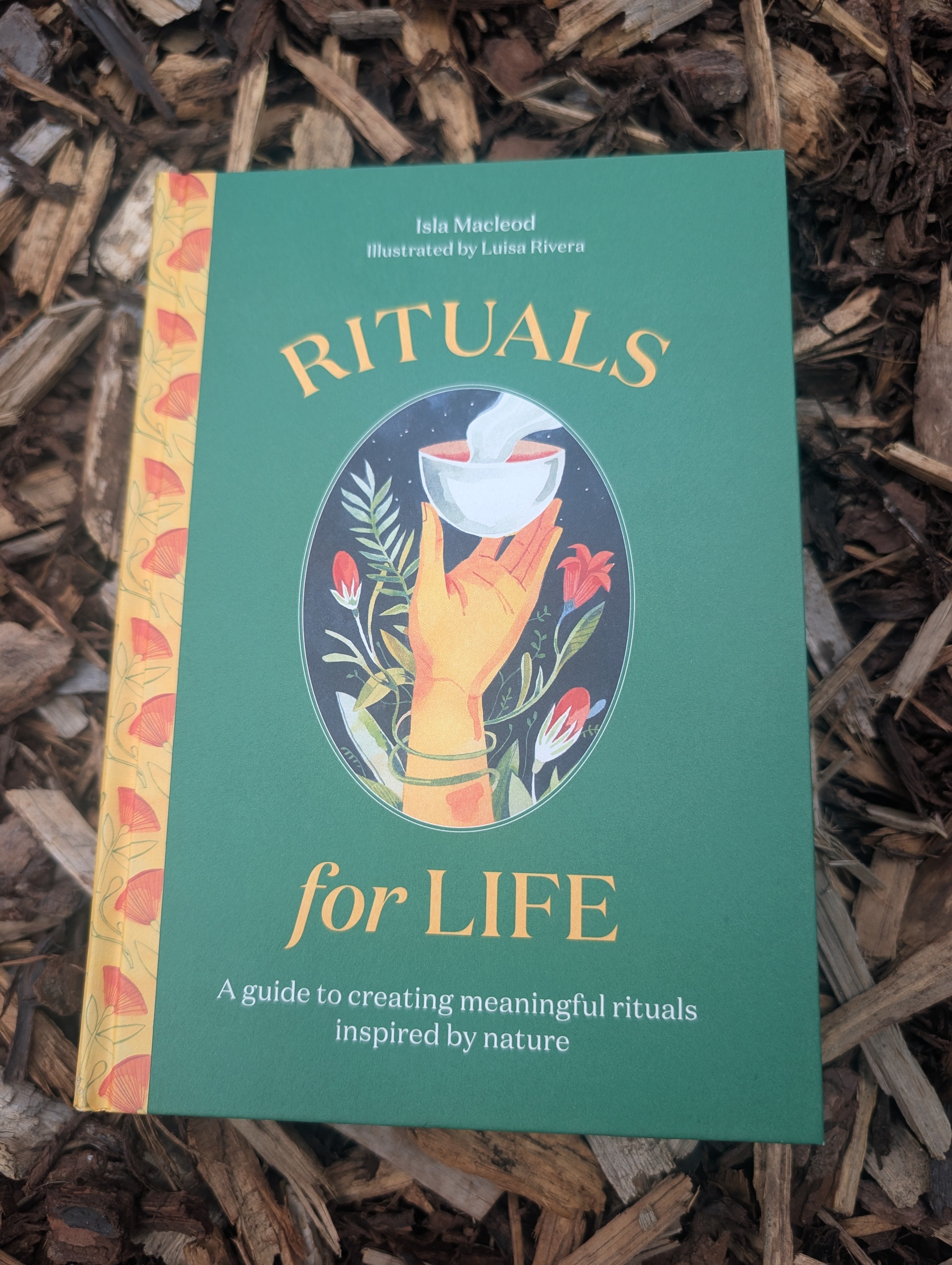 Book titled 'Rituals for Life' on a wooden surface