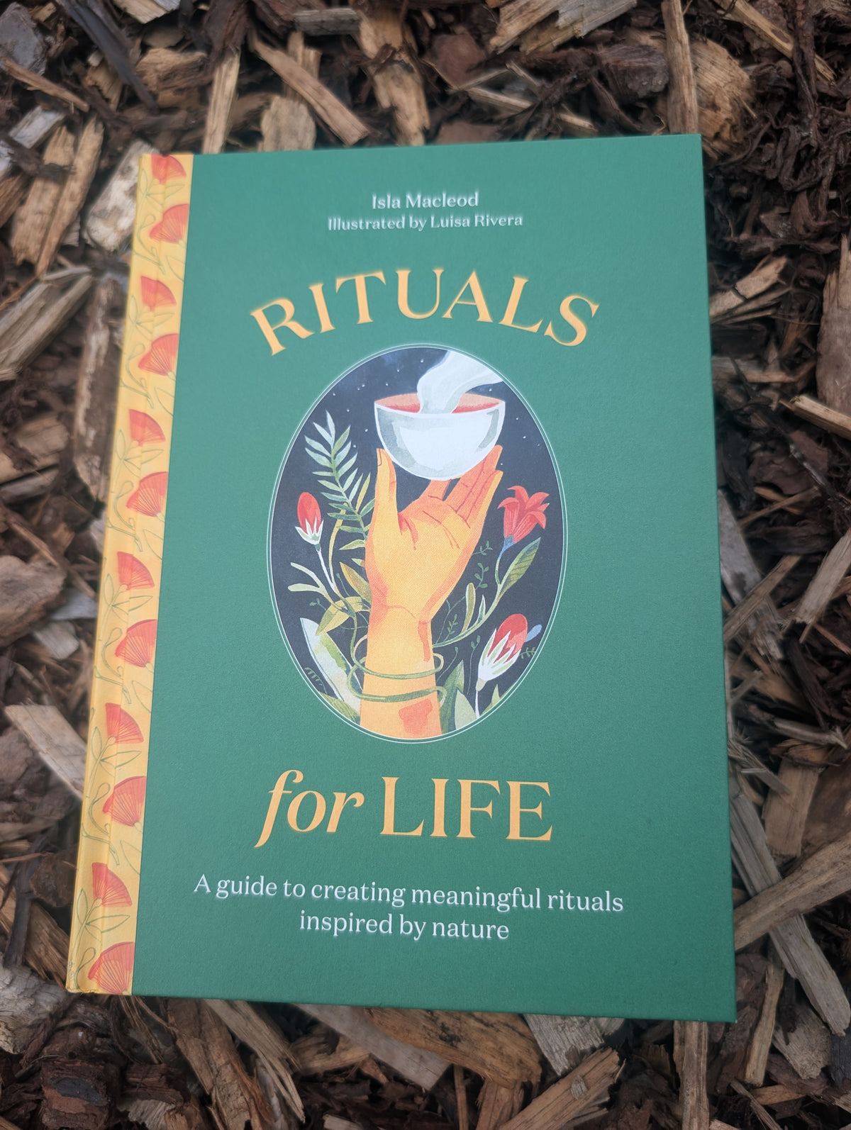 Book titled 'Rituals for Life' on a wooden surface