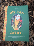 Book titled 'Rituals for Life' on a wooden surface