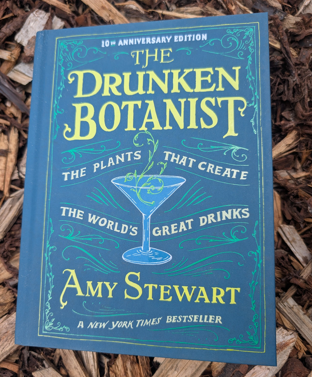 Book titled 'The Drunken Botanist' by Amy Stewart on a wooden surface